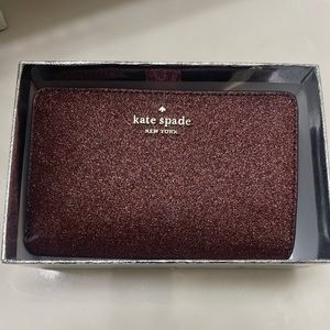 Plum colored Kate Spade wallet. New condition Non smoking home.